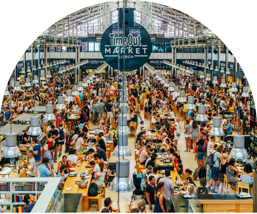 An aerial view of a covered food hall filled with guests eating.